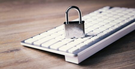 a computer keyboard with a padlock on top of it