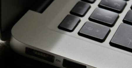 Free Detailed view of a silver laptop showing keyboard and multiple ports. Stock Photo