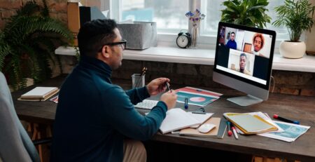 teacher-video-calling-with-his-students-using-a-computer
