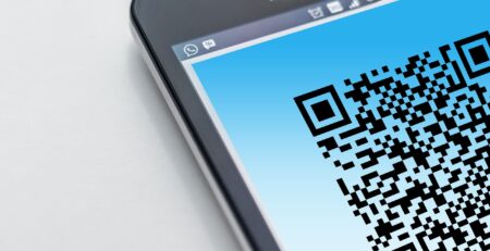 Free High-resolution close-up of a smartphone displaying a QR code on its screen. Stock Photo